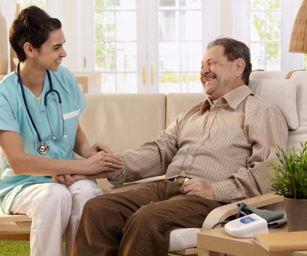 Nurse,Measuring,Blood,Pressure,Of,Senior,Man,At,Home.,Smiling